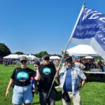 Rob Kristofferson, Jordyn Perreault-Laird and Ryan Ladner at Labour Day waving WLUFA Flag